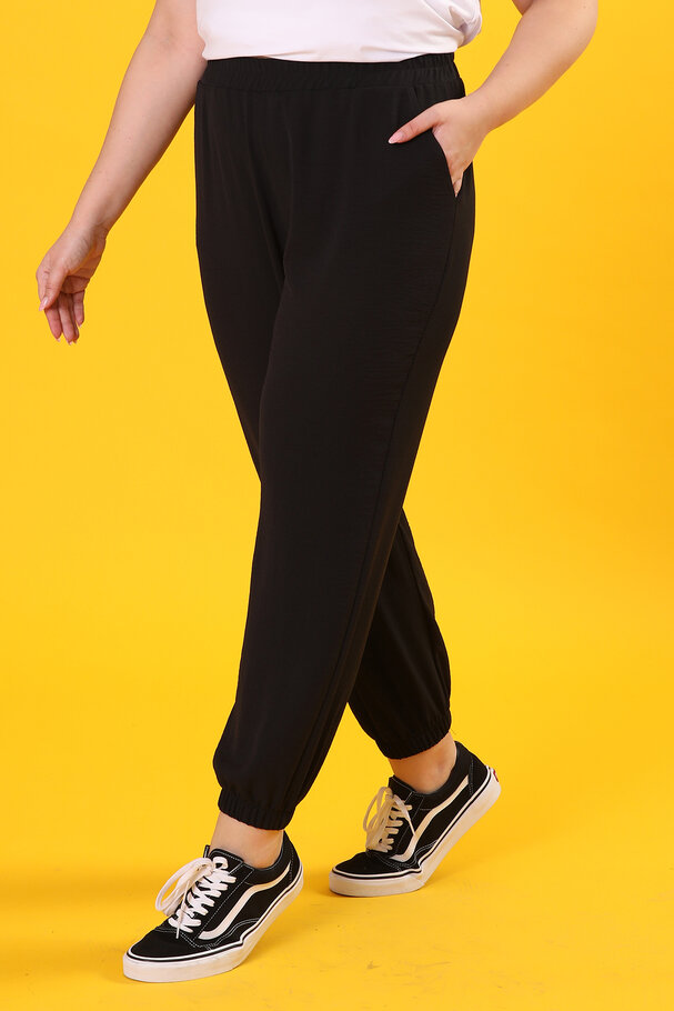 TROUSERS WITH FLOWING FABRIC