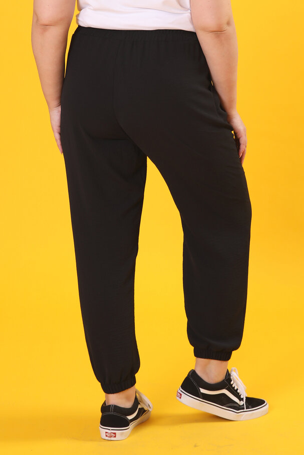 TROUSERS WITH FLOWING FABRIC